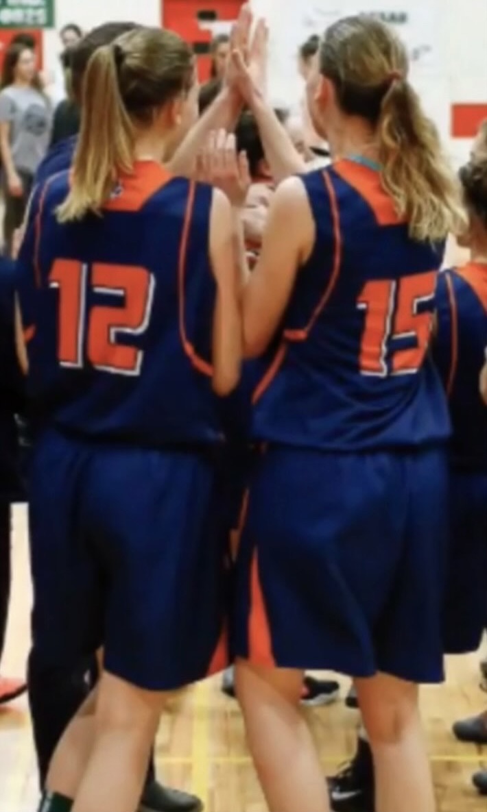 Sydney and Bailey In a huddle during a timeout
