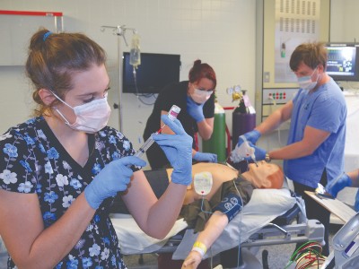 Several nursings around a dummy practicing