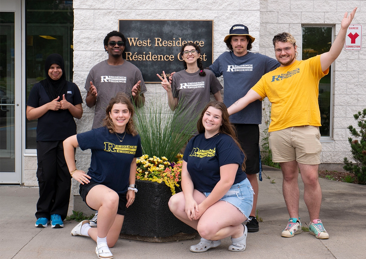 The Laurentian University Residence Assistants posing in front of West Residence.