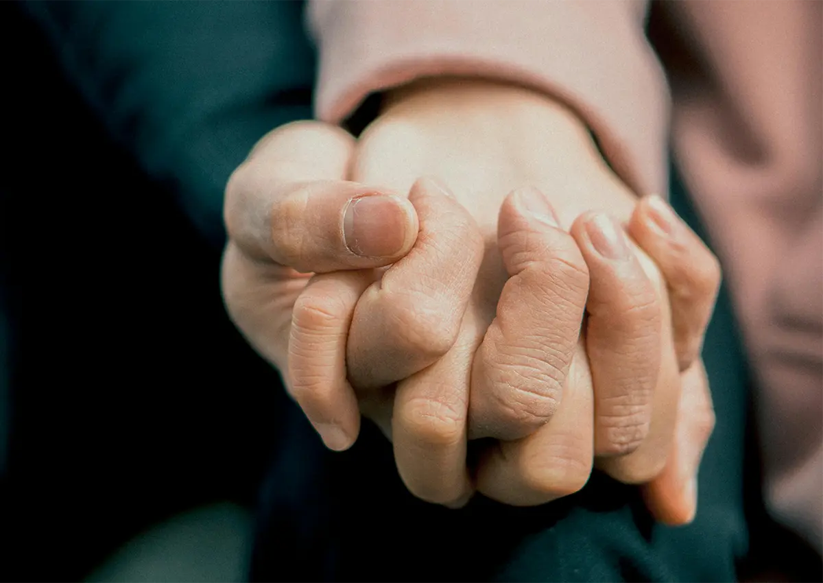 Closeup of 2 people holding hands