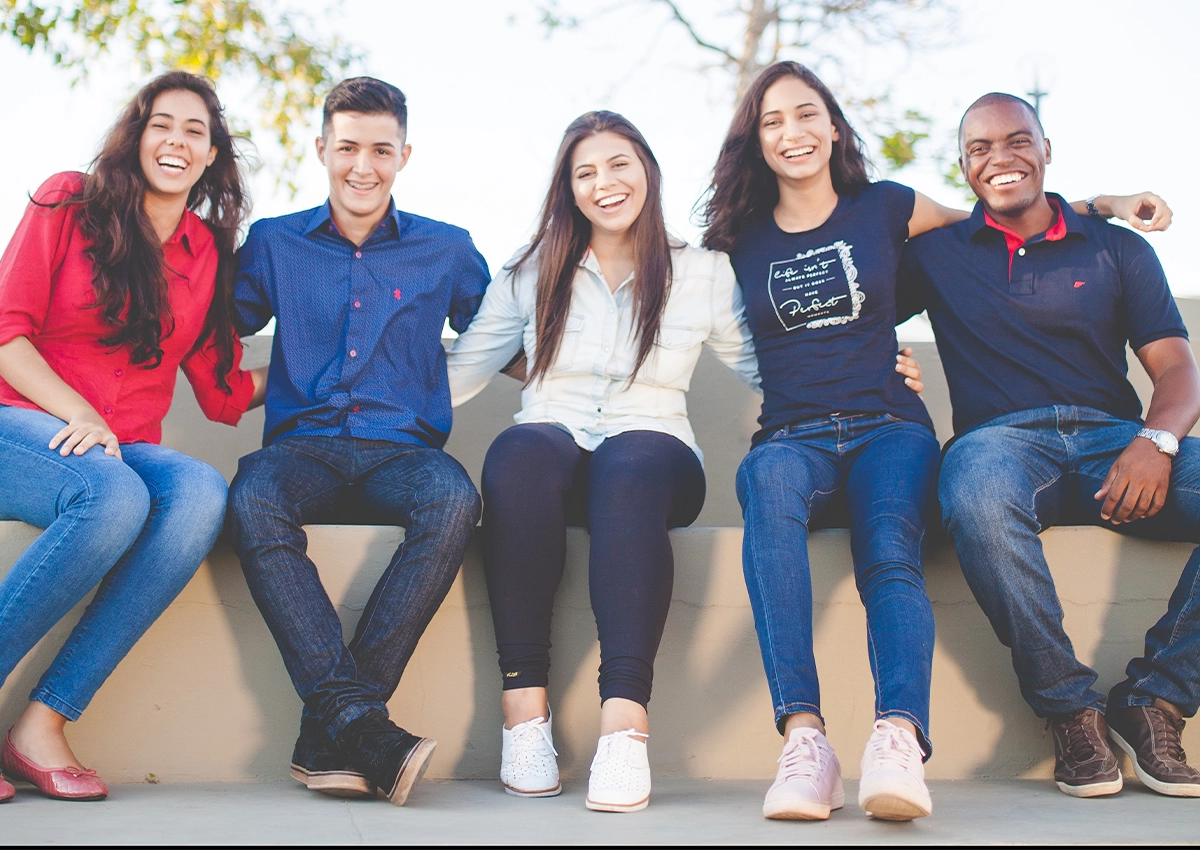 students sit outside on a sunny day