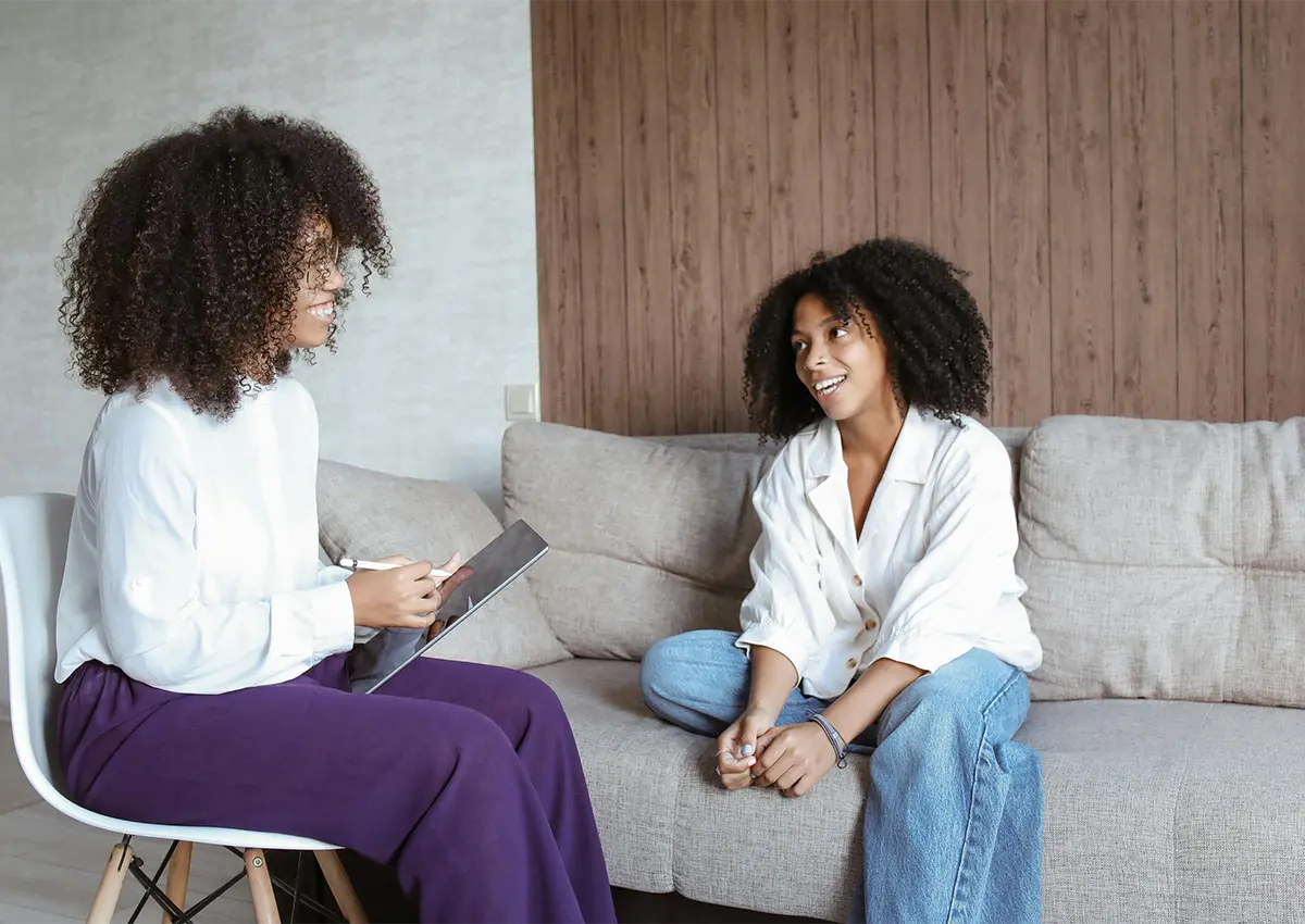 Student talking to another student thats holding a clipboard