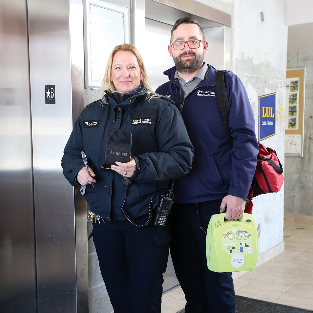 Two Laurentian University security guards smiling.