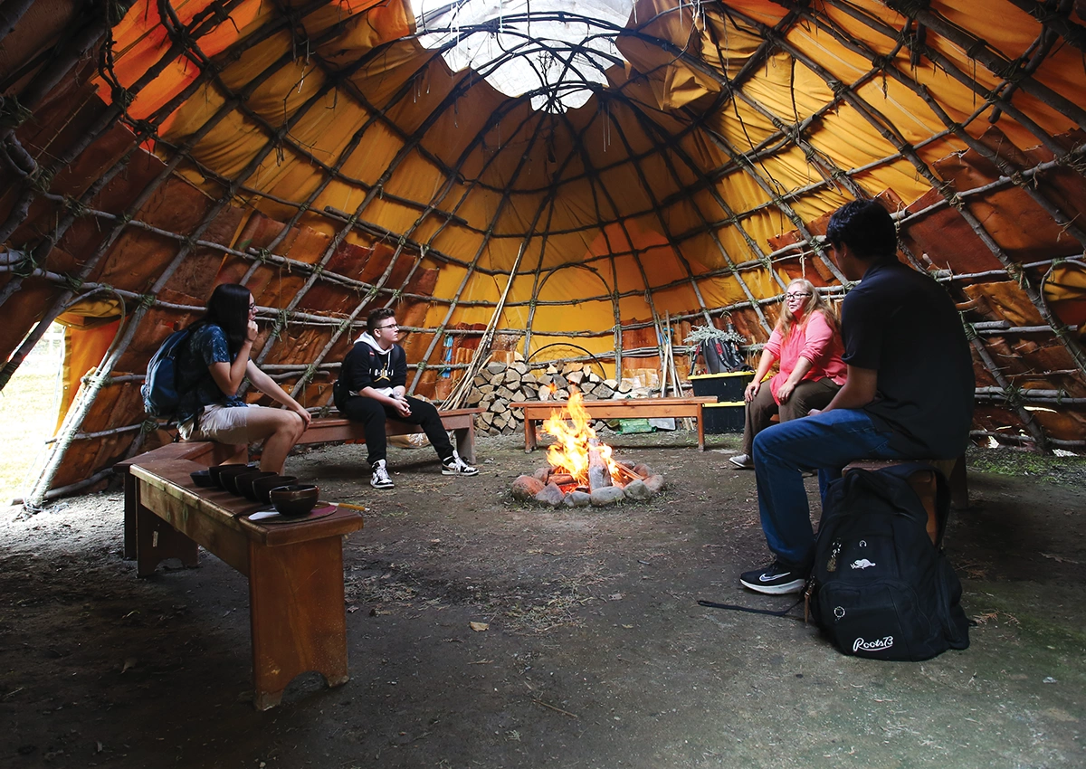 A group of Laurentian University students in a Wigwaam.