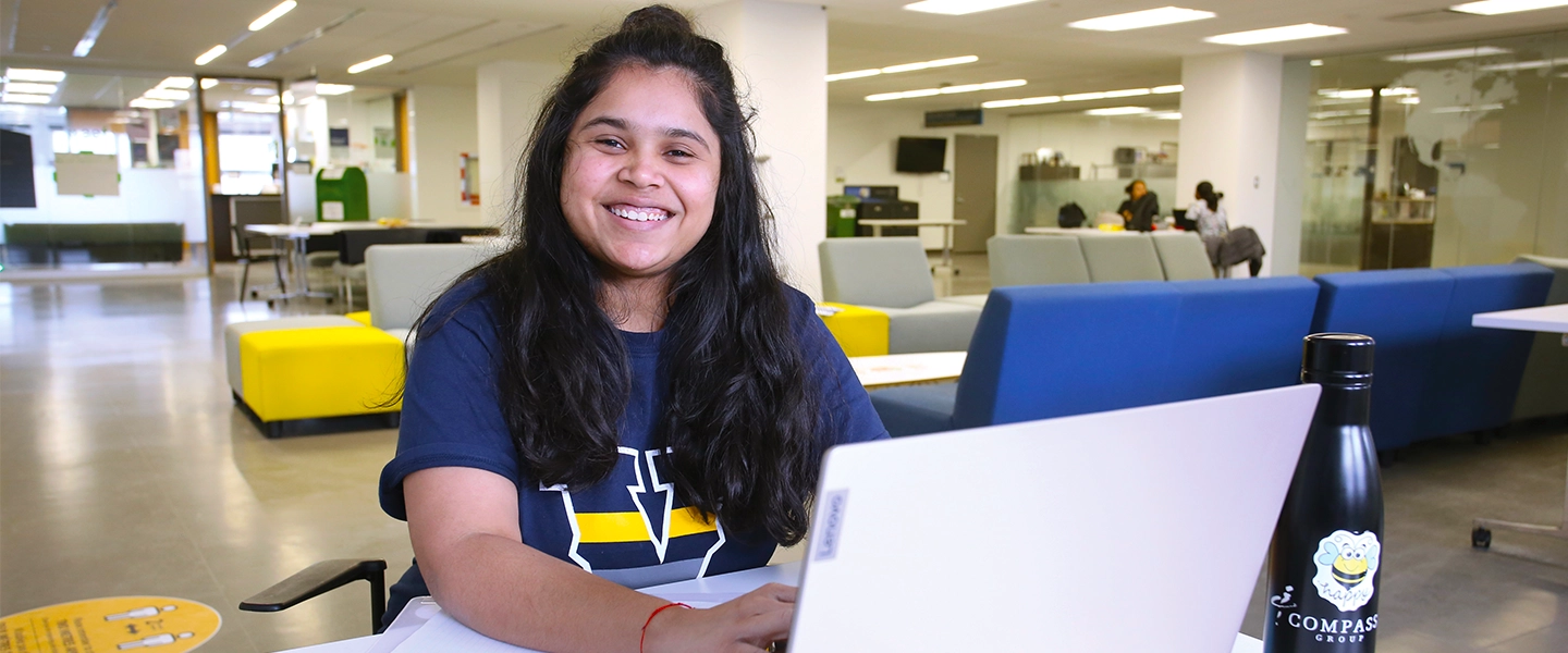 A Laurentian University student on her laptop on the third floor of the R.D. Parker building.