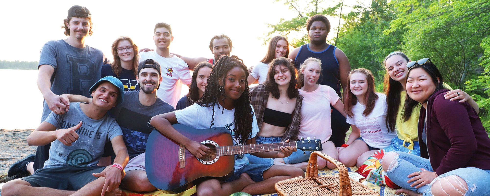 Laurentian University students sitting together at the Laurentian Beach on Beach Day.