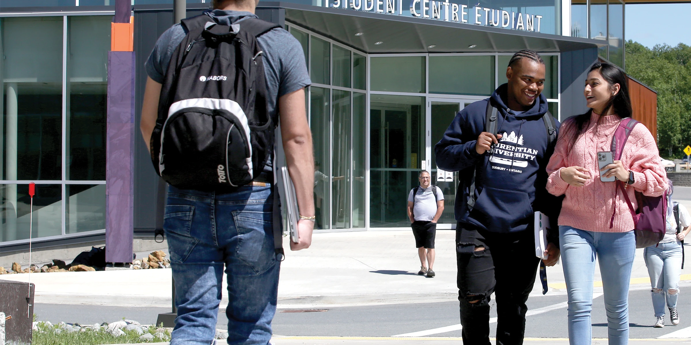 Two Laurentian University students walk through campus.