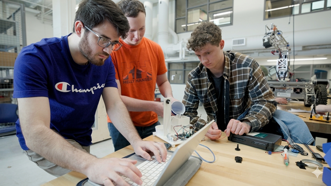 3 people working with their Capstone project