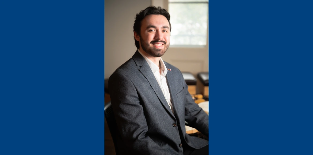 Headshot of Dylan Rietze, the newly appointed Industry Liaison Officer at Laurentian University, smiling in a grey blazer and white shirt.