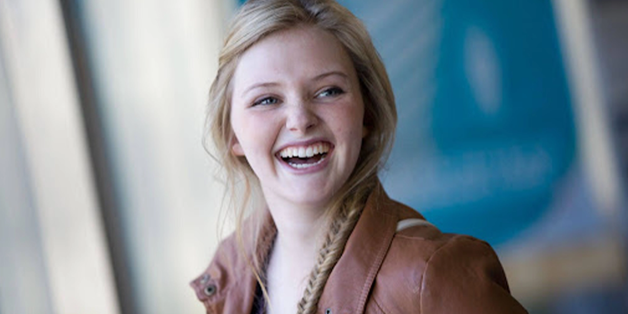 Woman in leather jacket smiling at camera 