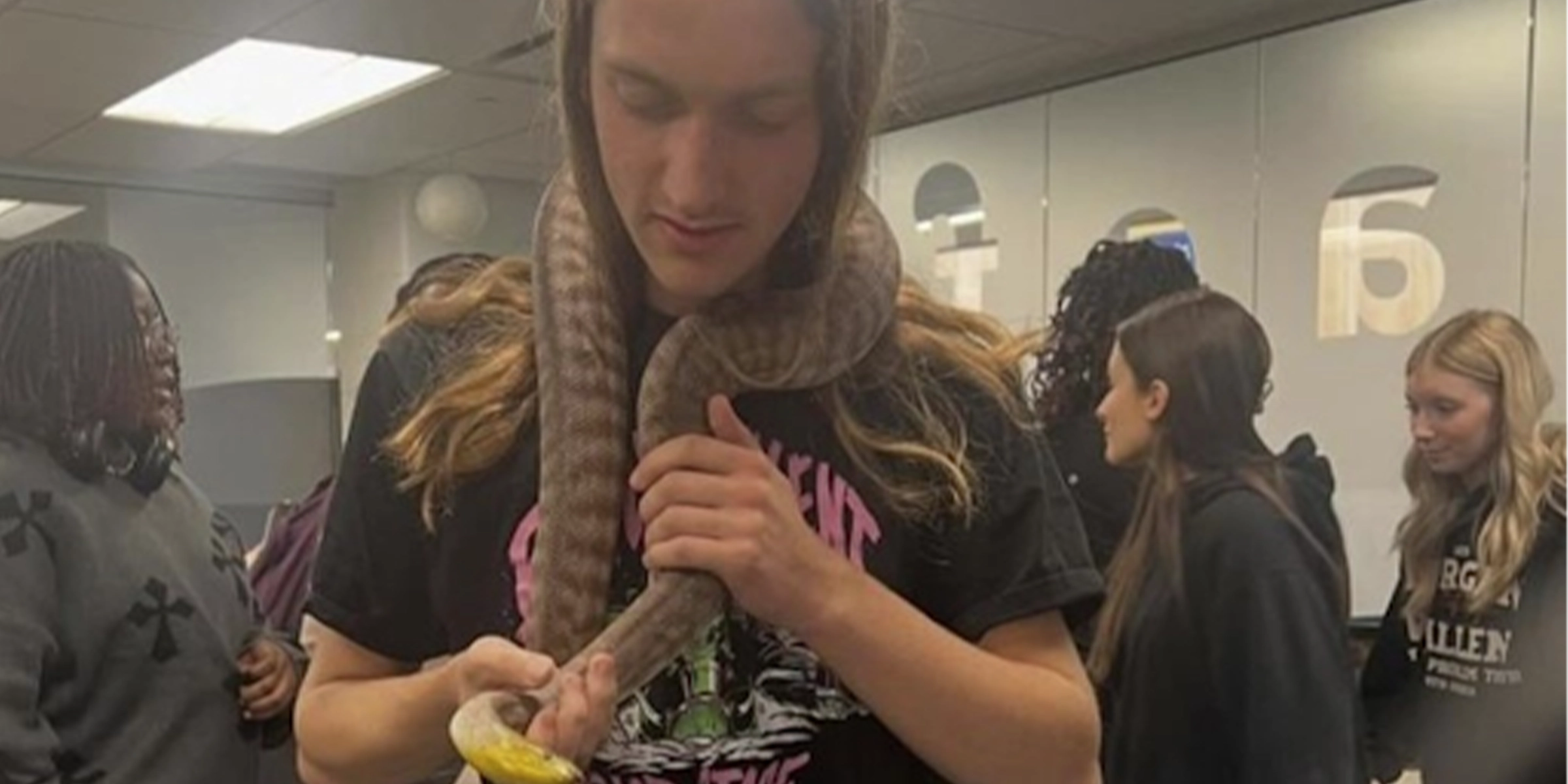 Student holding a snake