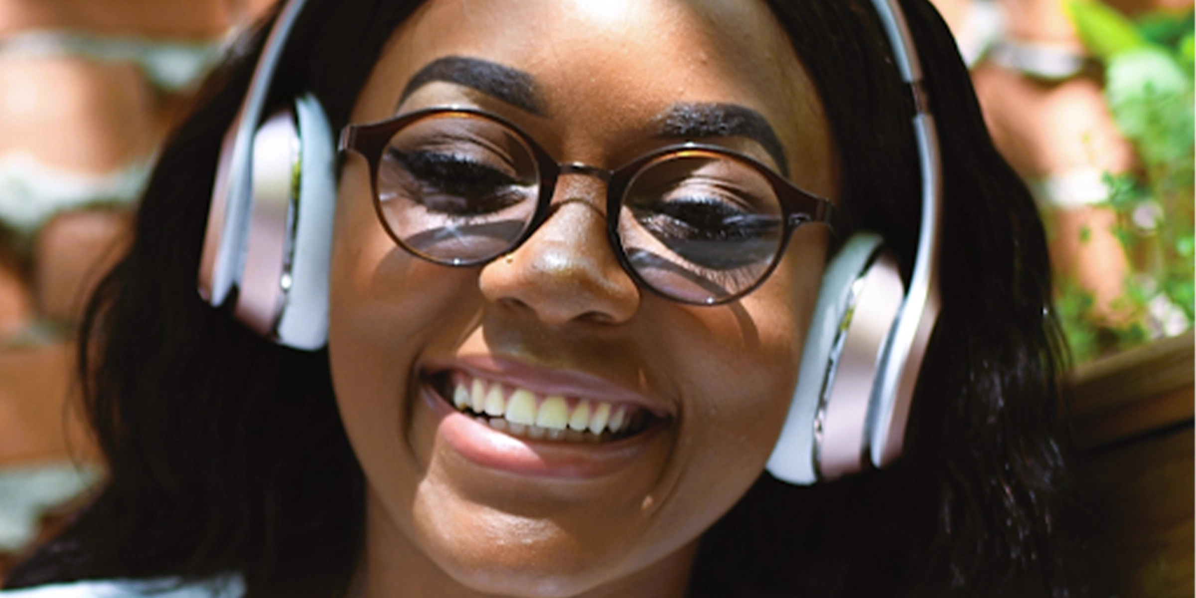 person wearing headphones smiling at camera