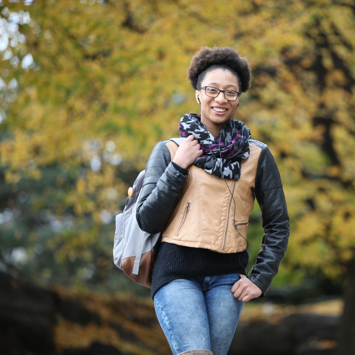 A Laurentian University student walking outside in the Fall.