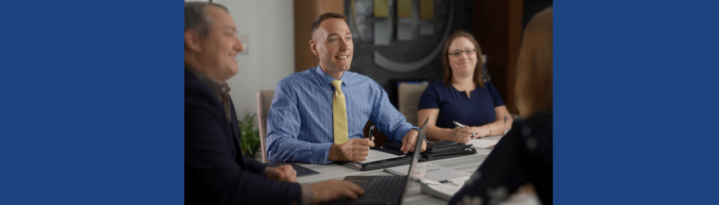 JF sitting at table with colleagues