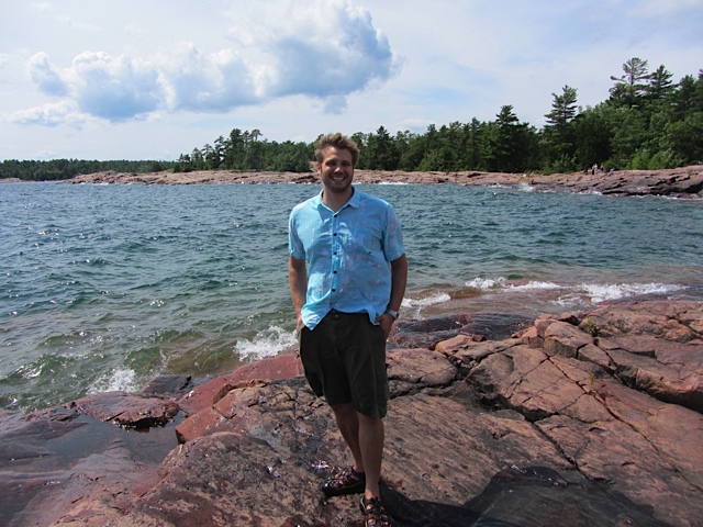 Nathan Basiliko standing in front of a lake 