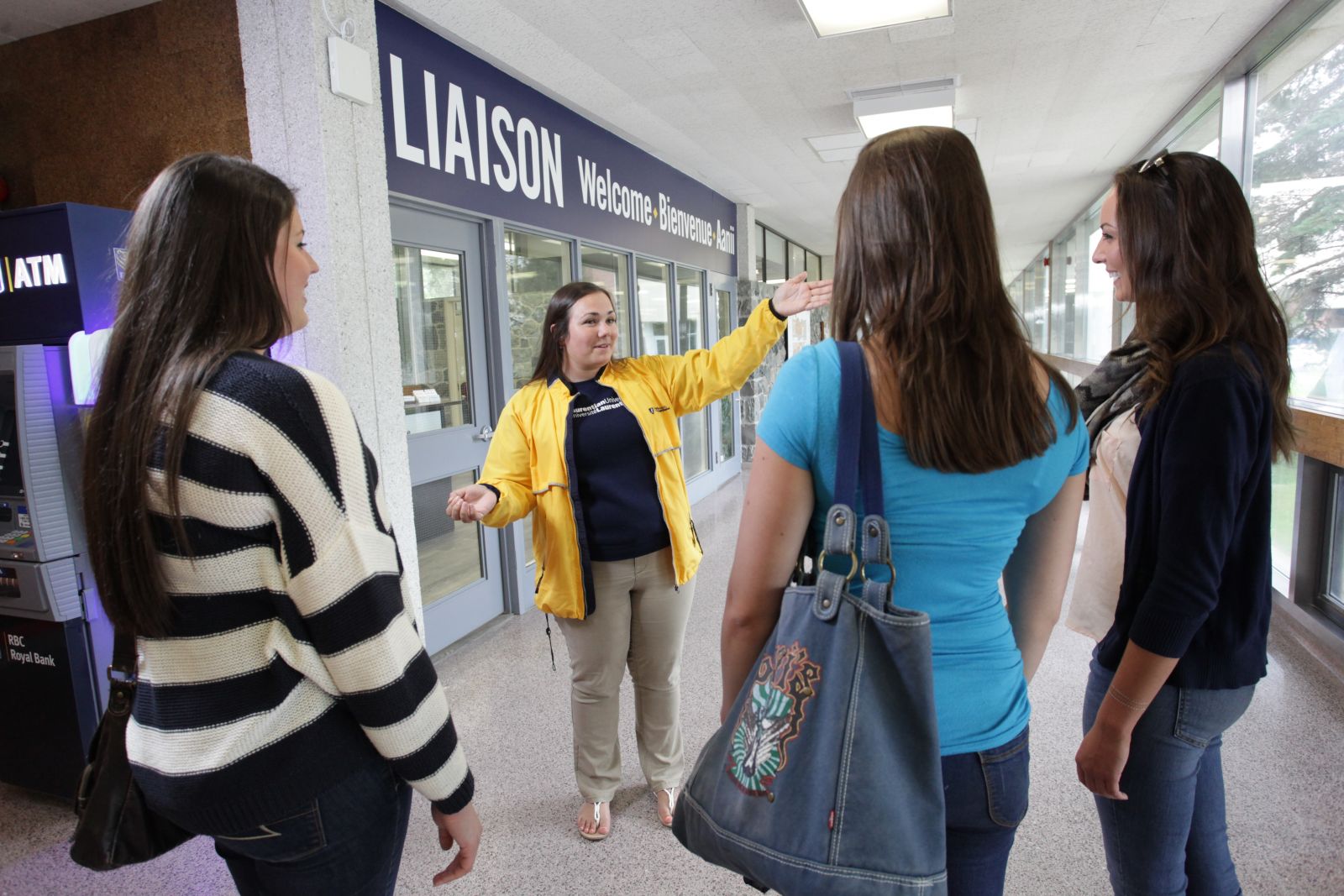 A recruitment officer giving a tour of Laurentian University to students.