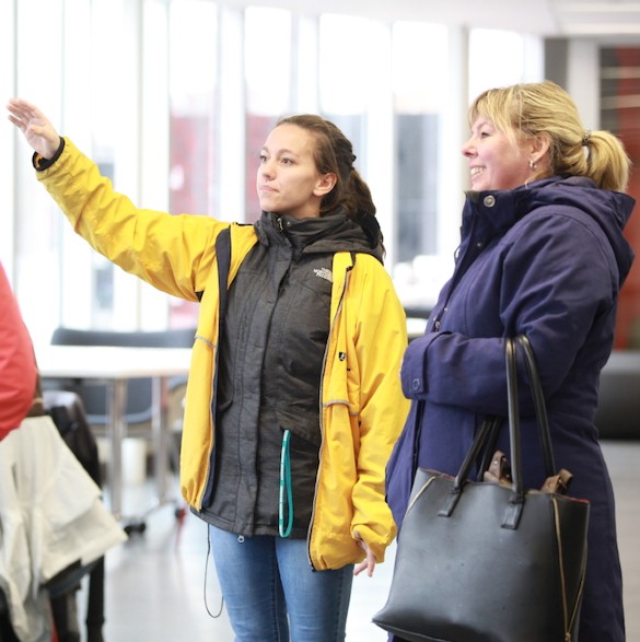 A student giving a tour of campus to parents and future applicants