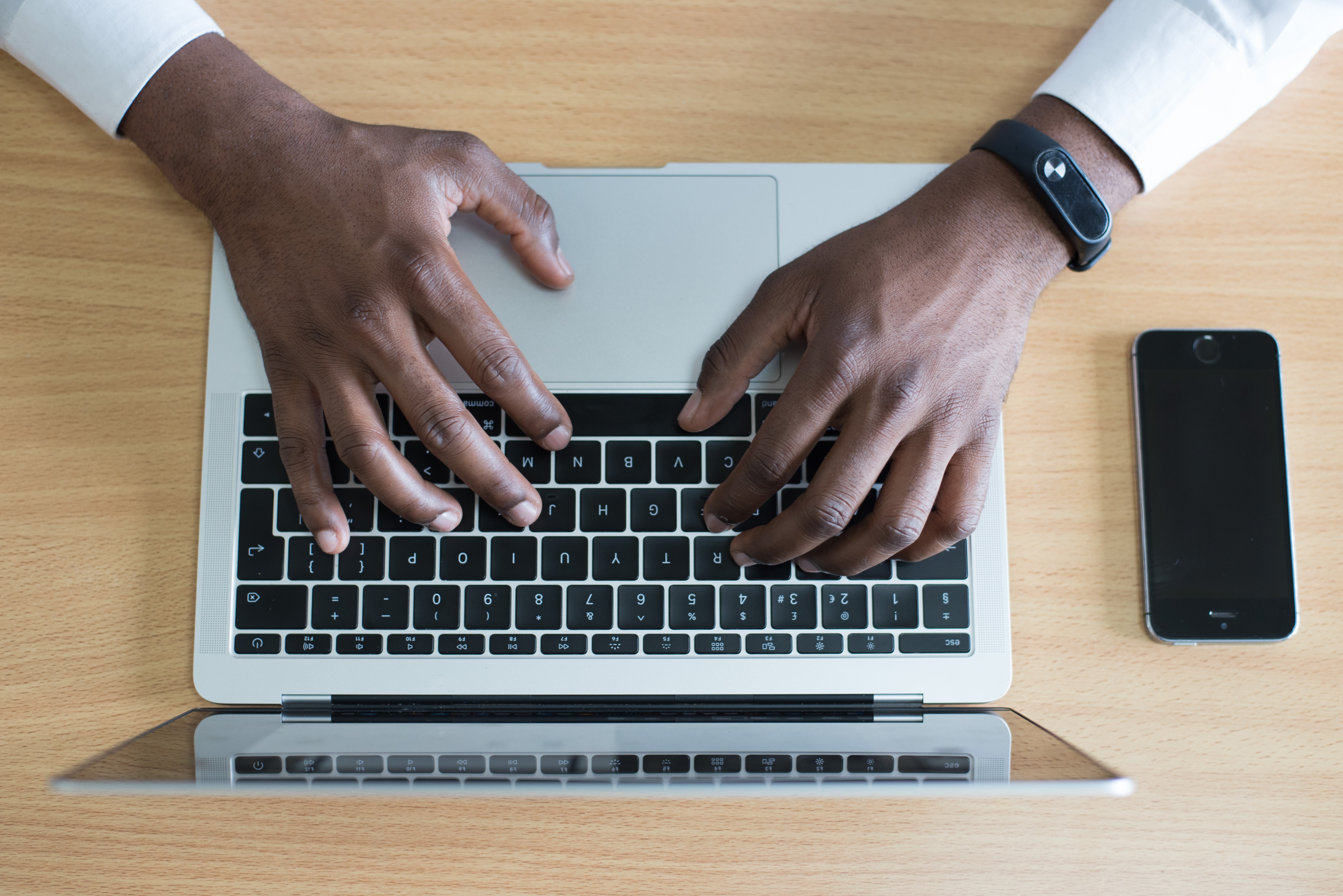 An overhead of someone typing on keyboard