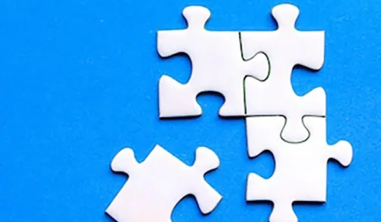 white puzzle pieces on a blue background