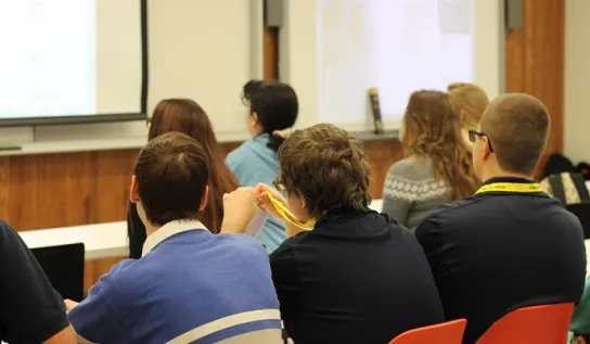 students sit in class