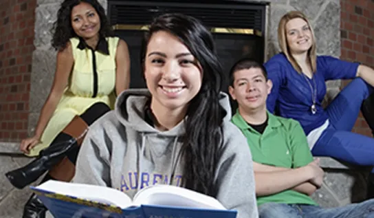 Students smiling in the Brenda Wallace Reading Room.