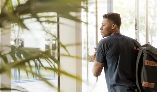 Student walking out of a doorway.