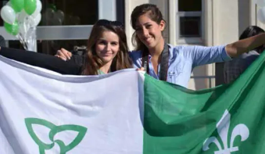 Two students holding a Franco-Ontarian flag