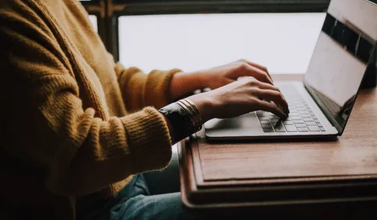 Someone typing on a laptop