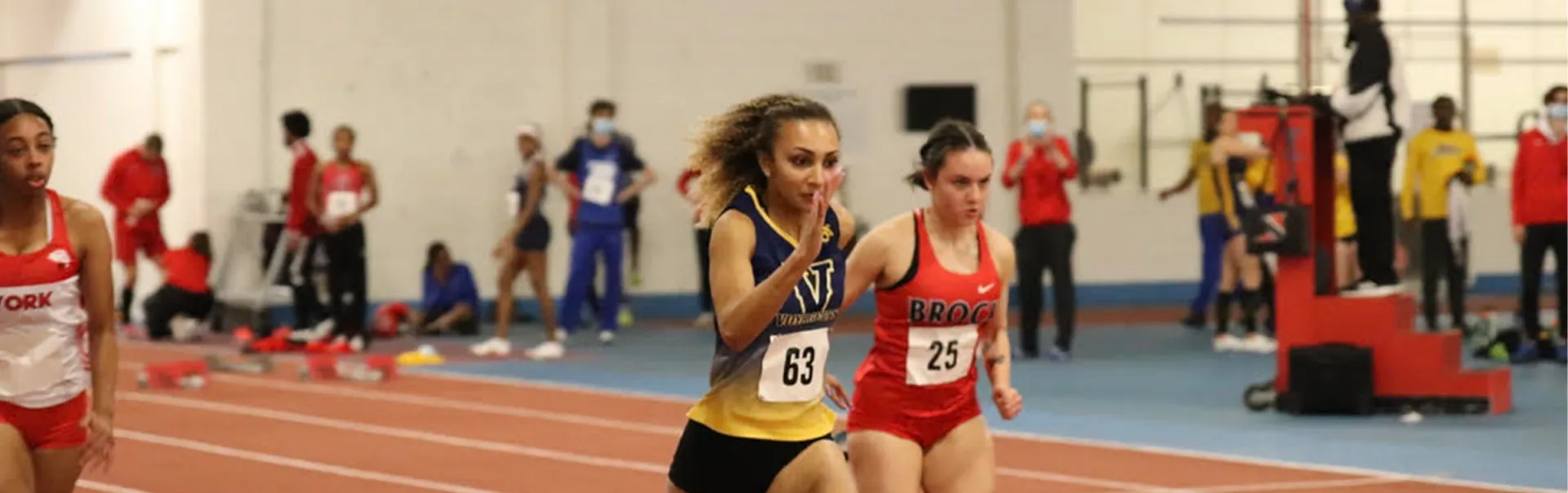 student naomi palmer runs a track and field race at the indoor track