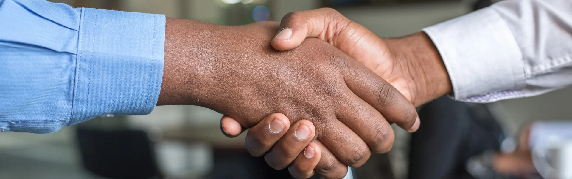 A closeup shot of two people shaking hands.