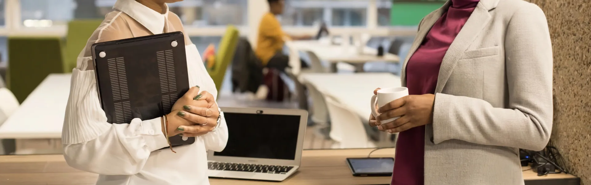 Two office workers talking to each other.