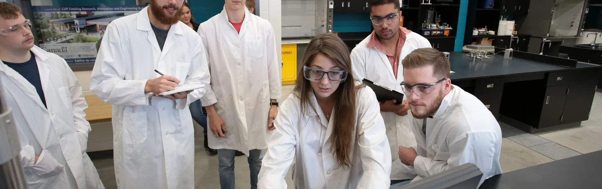 Students in lab coats in a chemical engineering lab