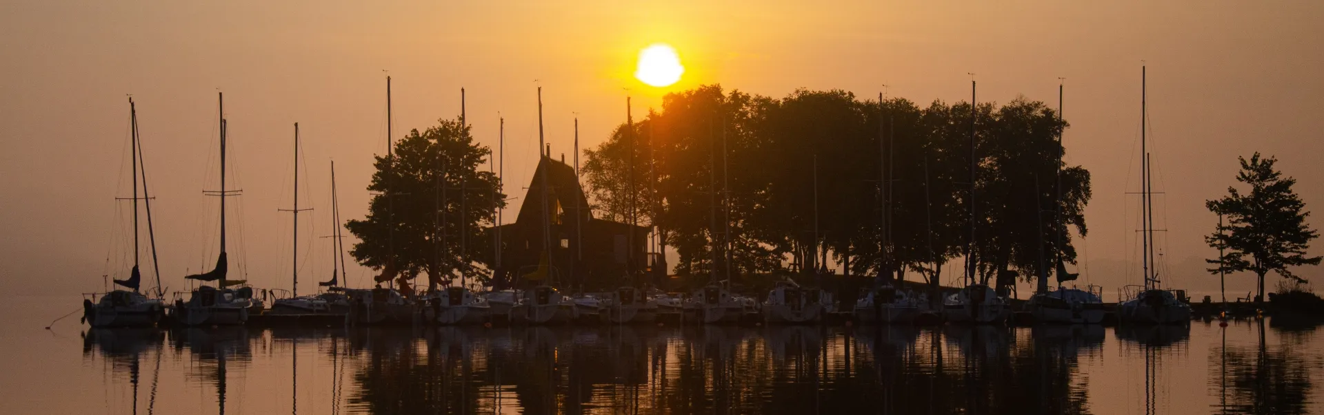 Docked boats during sunset