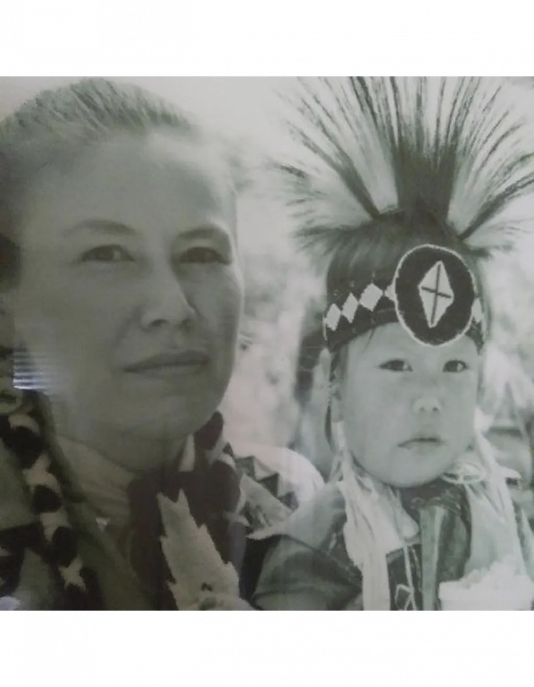 Paskwa Lightning as a baby, dressed for a Pow Wow, with his mother.