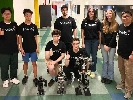 student team with the robots in the foreground
