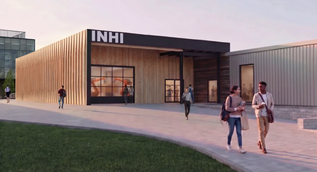 Institute for Northern Housing Innovation (INHI) -Architectural concept rendering of the Institute for Northern Housing Innovation (INHI) building expansion. The modern, single-story mass timber structure features vertical light-wood siding and a large glass over-head doors showcasing research activities occurring in the workshop interior. 