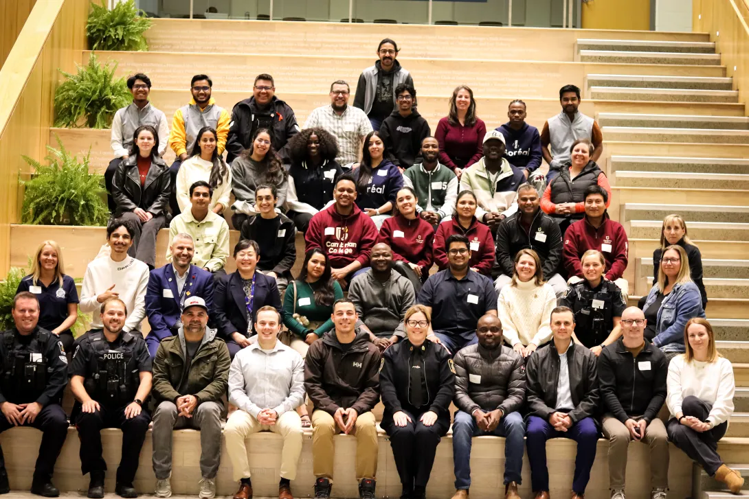Large group photo of participating international students, community organizers, and police officers. 